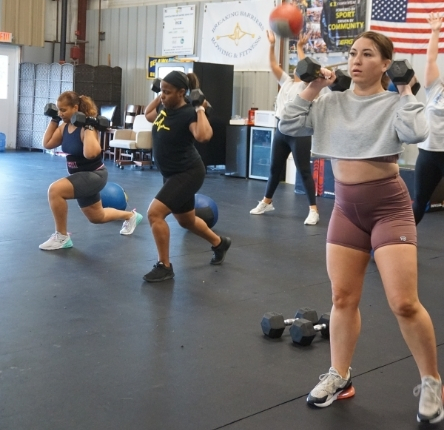 three women lifting weights