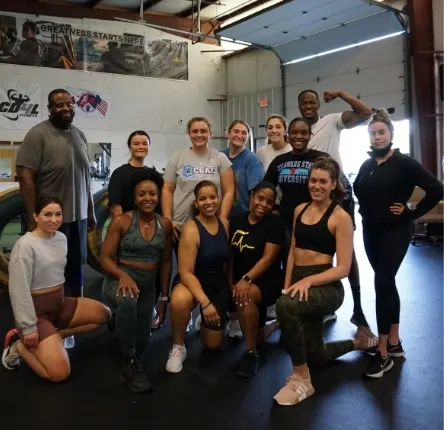 breaking barriers personal trainer vaughn poses with his clients