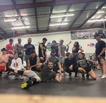 a diverse group of people show off their muscles after a workout