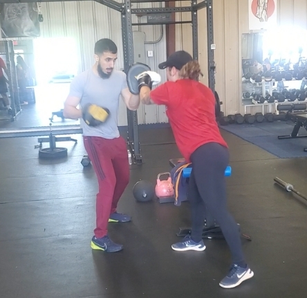 a woman works out with her personal trainer